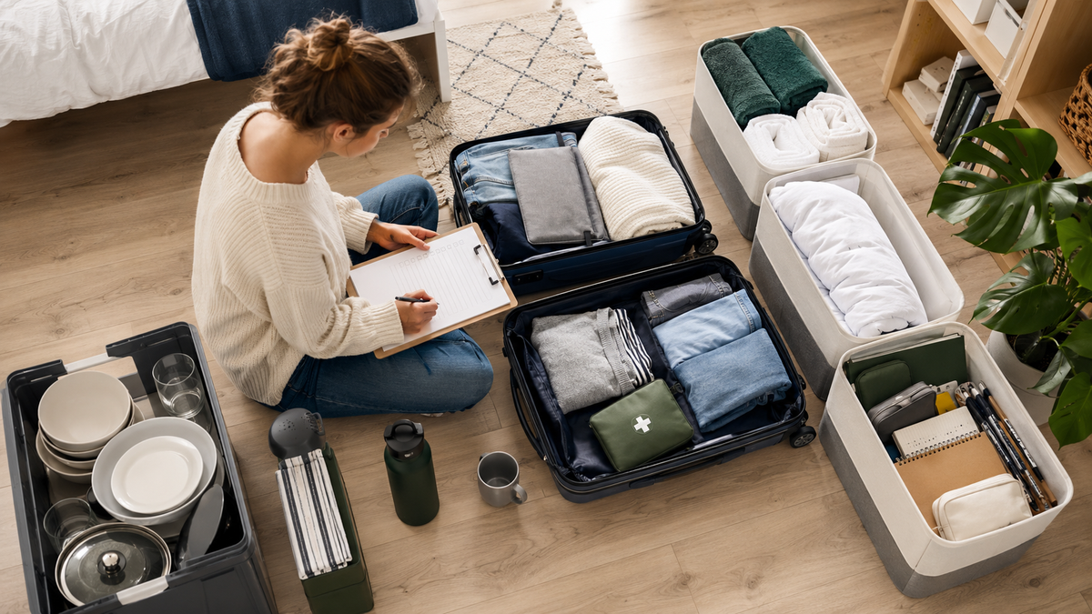 Student grouping practical university essentials into suitcases and storage boxes